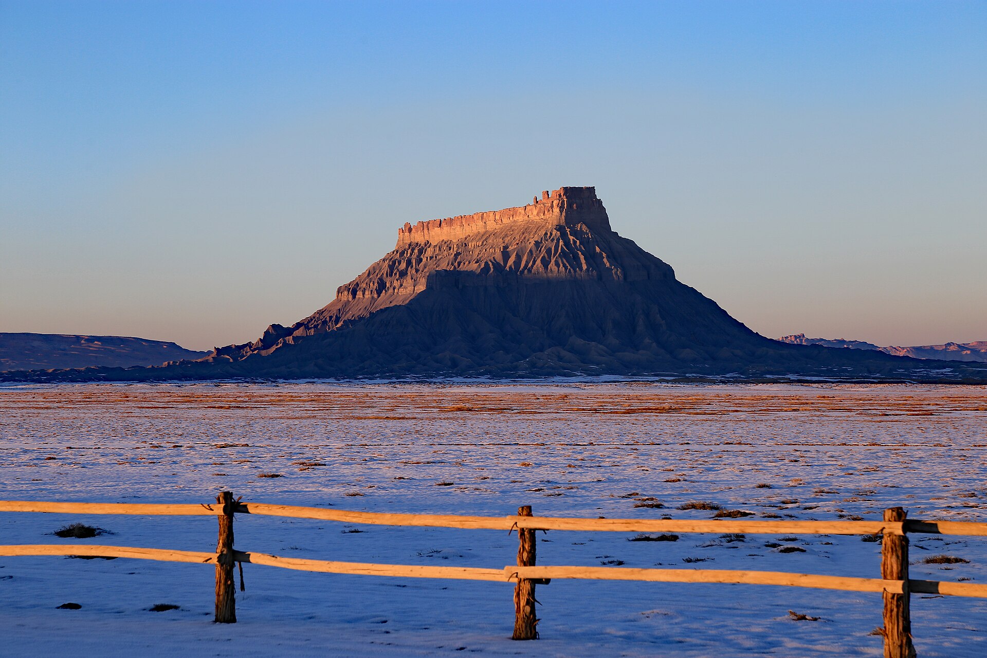 Factory Butte rising over grey badlands west of Hanksville, Utah
