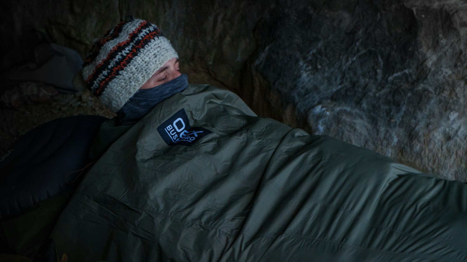Camper sleeping warmly in a sleeping bag on a cold night