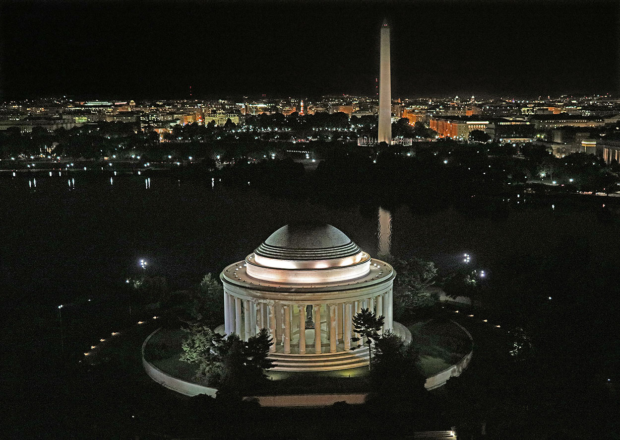 The Jefferson Memorial lit up at night across the Tidal Basin in Washington DC