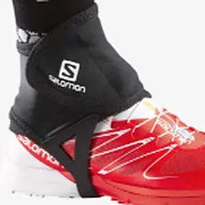 Salomon Trail Gaiters Low in black with an underfoot strap on a red trail shoe