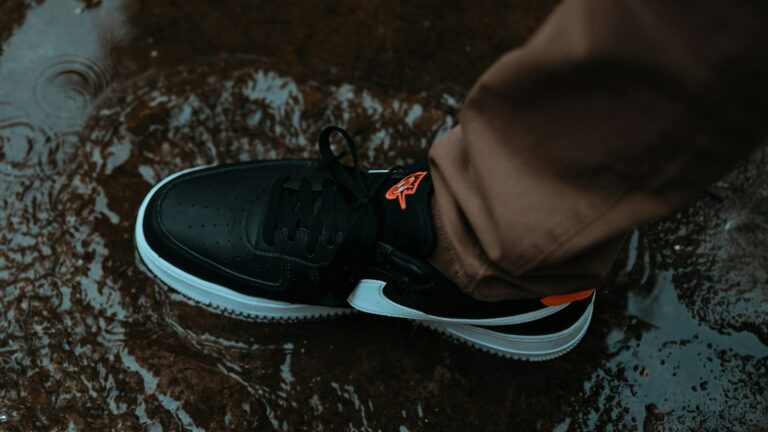 Traveler standing in a rain puddle wearing black sneakers