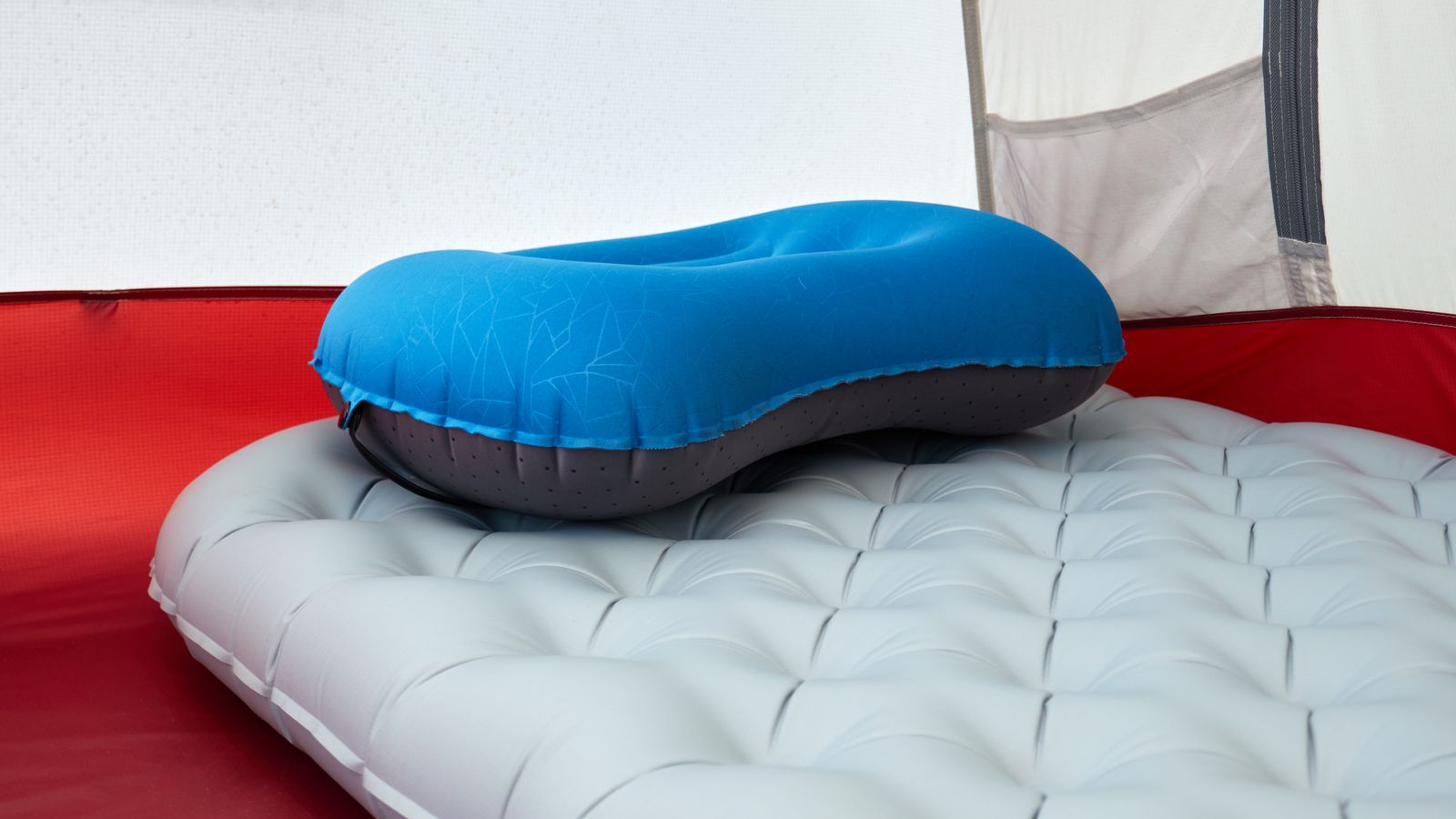 Ultralight inflatable sleeping pad with a pillow inside a backpacking tent