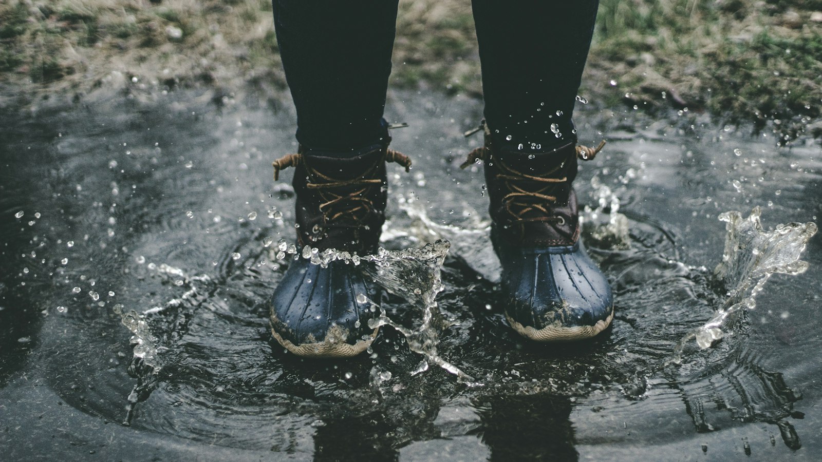 Waterproof boots stepping into shallow water